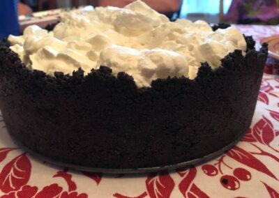 No-bake chocolate cream cake in an oreo crust topped with whipped cream