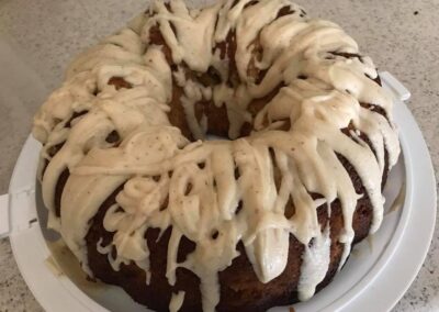 Peach Bundt cake with thick brown butter icing streaks