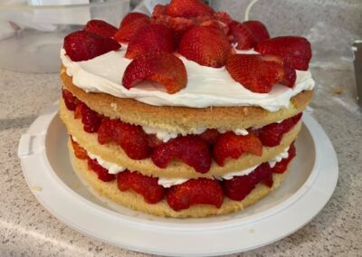 Layered vanilla cake with strawberries and cream cheese icing